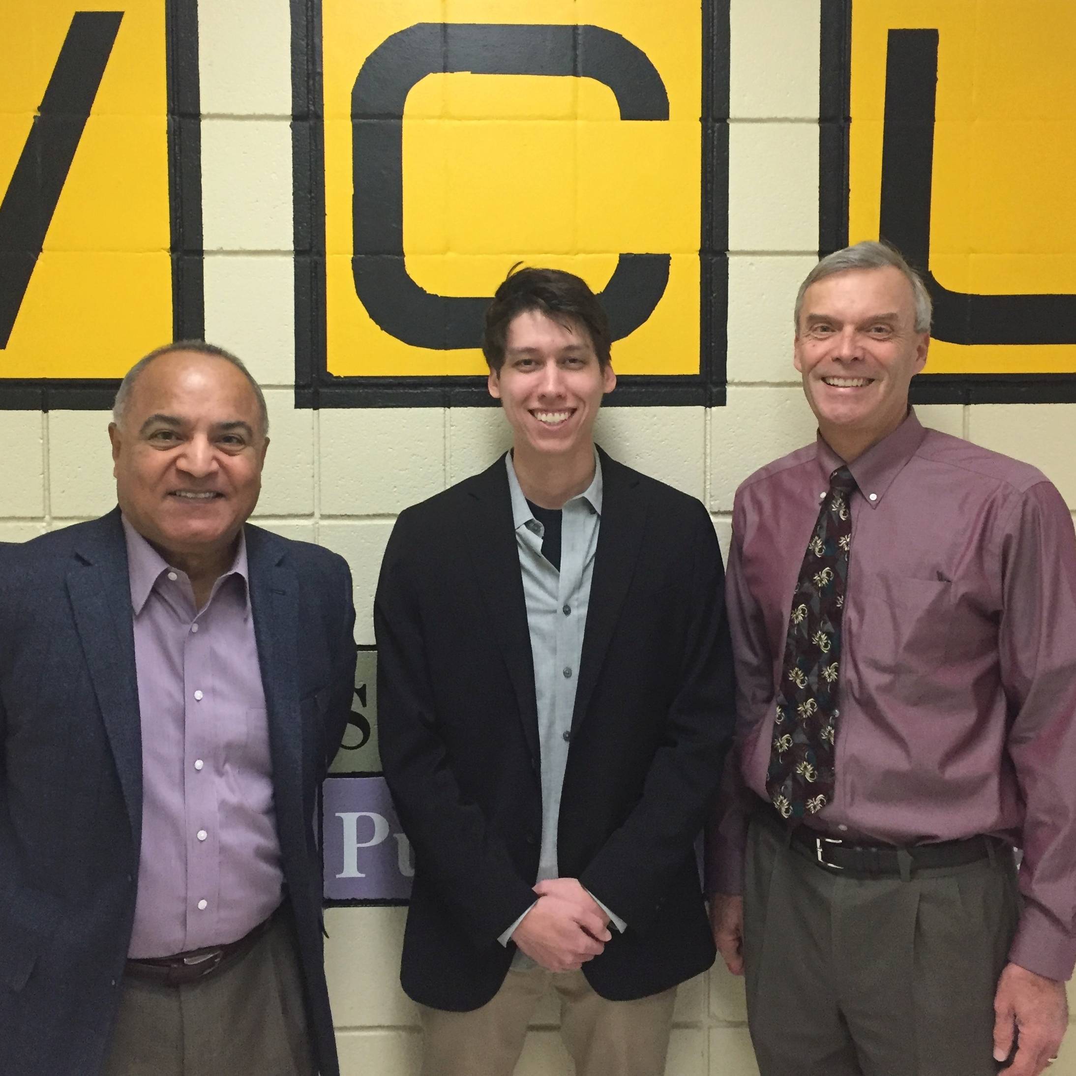 Samy El-Shall, Kevin Theisen and Scott Gronert pose in front of a mural in the department of chemistry.